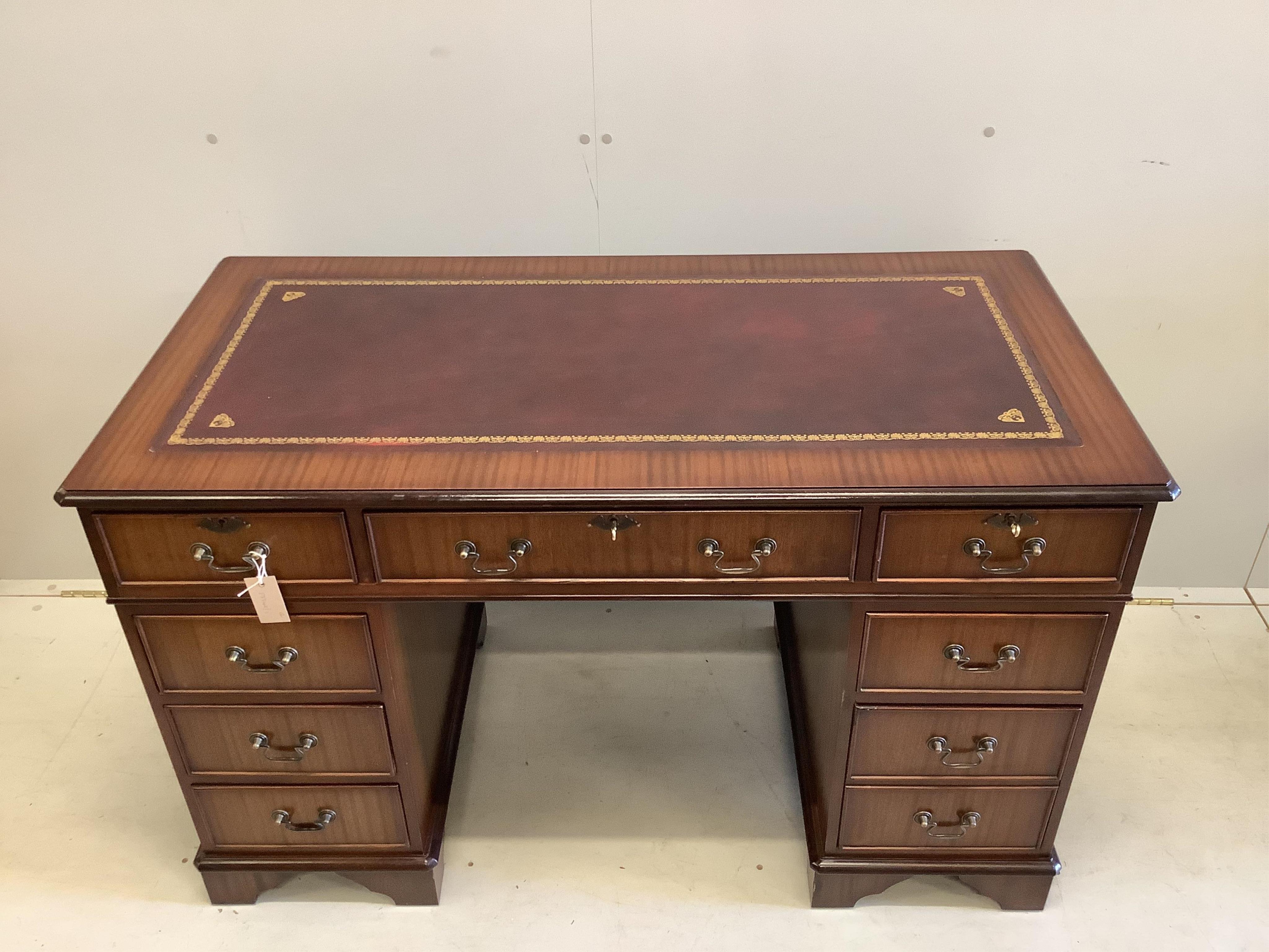 A reproduction Victorian style beech and burgundy leather swivel desk chair, together with a reproduction mahogany pedestal desk, width 121cm, depth 61cm, height 76cm